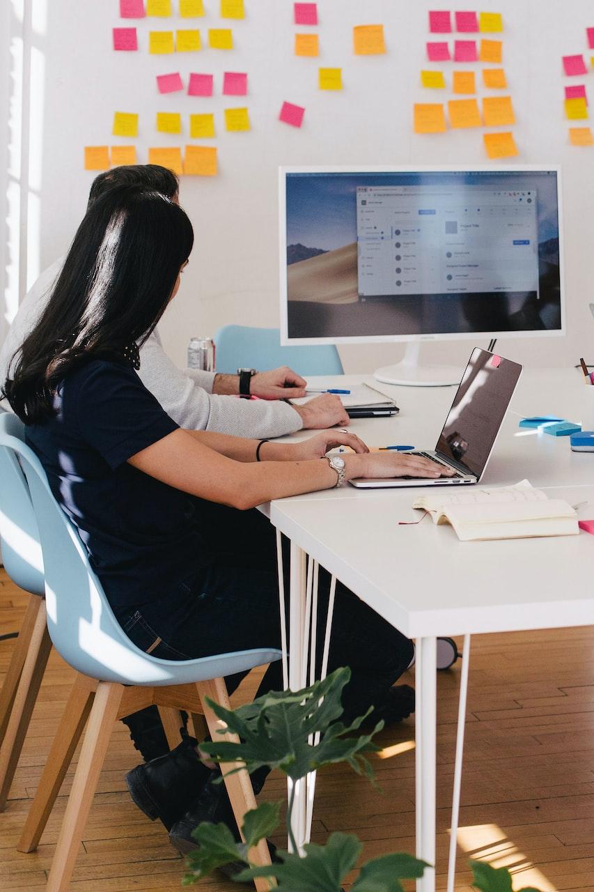 five person by table watching turned on white iMac